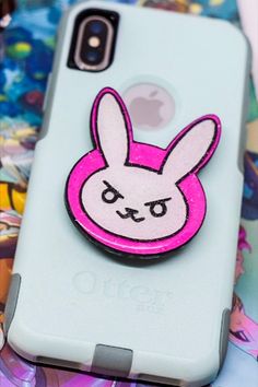 a phone case with an image of a rabbit on it's back and pink ears