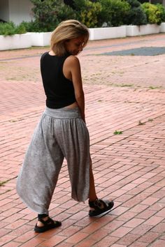 a woman standing on top of a brick road