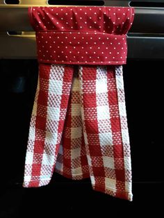 red and white checkered cloth hanging from the oven