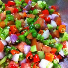 a bowl filled with lots of different types of veggies on top of it