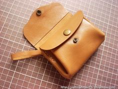 a small tan leather pouch sitting on top of a table