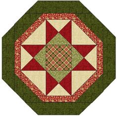 a quilted square with red and green designs on the center, surrounded by smaller squares