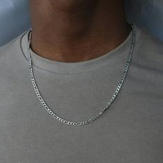 Introducing our Silver Figaro Necklace for Men. Crafted with precision and timeless elegance, this necklace exudes confidence. Its classic link pattern and polished finish add sophistication to any outfit.  ● Materials: - 316L Stainless Steel ● Chain Type: - Figaro ● Sizing: - Chain length: 20 inches (50 cm) - Figaro width: 4mm  ● Durability: - All Livin Well Jewelry is tough, durable, and rust-proof. It won't discolor or turn your skin green. It's waterproof, perfect for showers, pools, and any water activities. You can even wear it while working out or in hot and sweaty conditions. ● Warranty:  - Still not sure if this piece is for you? Don't worry, all of our jewelry comes with a lifetime warranty. If for any reason you are not satisfied with the quality or it breaks, you can request a Figaro Necklace, Figaro Chain Necklace, Necklace Men, Mens Silver Necklace, Mens Jewelry Necklace, Mens Chain Necklace, Figaro Chain, Long Chain Necklace, Necklace For Men