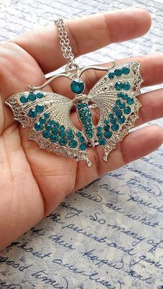 Blue Butterfly Charm Jewelry For Party, Blue Embellished Jewelry Gift, Embellished Blue Jewelry As Gift, Butterfly-shaped Rhinestone Party Jewelry, Butterfly-shaped Party Jewelry With Rhinestones, Butterfly Shaped Party Jewelry With Rhinestones, Party Jewelry With Rhinestones And Butterfly Shape, Party Jewelry With Rhinestones In Butterfly Shape, Blue Crystal Embellished Jewelry Gift