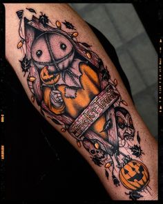 a person with a halloween themed tattoo on their arm