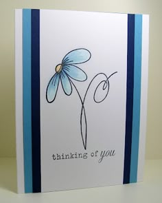 a blue and white greeting card with a flower on the front that says thinking of you