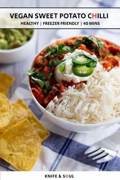 a white bowl filled with rice and veggies next to tortilla chips