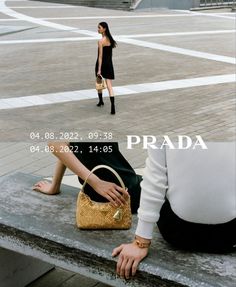 a woman sitting on top of a cement bench next to a person holding a purse