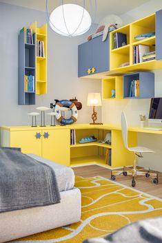 a bedroom with yellow and blue furniture, bookshelves and a white ceiling light