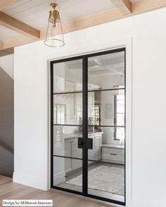 an open glass door leading to a kitchen