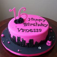 a pink and black birthday cake with the number fifteen on it