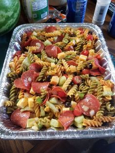 a pan filled with pasta salad on top of a table