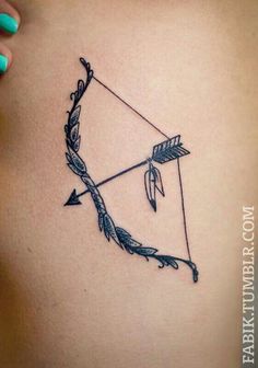 an arrow and bow tattoo on the back of a woman's shoulder, with arrows drawn