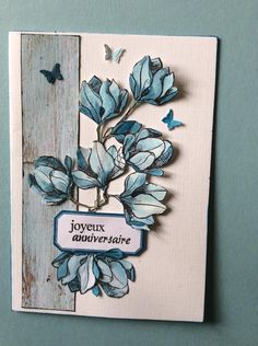 a greeting card with blue flowers and butterflies on the front, which reads joyeux anniverise