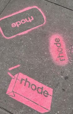 the sidewalk has pink chalk drawings on it with words written in black and red ink