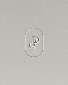 a close up of a button with the letter p in it's center on a gray surface