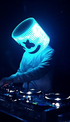 a dj mixing at a party in the dark