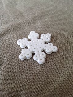 a white snowflake sitting on top of a bed