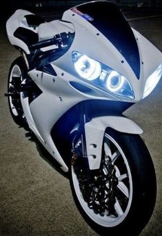 a white and blue motorcycle parked in a parking lot