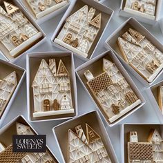 many small white and gold houses are in the same box, one is on top of another