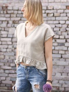 Linen loose crop top with frills. Breathable, soft and light thanks to the linen fabric. Perfect for a sunny days. Pair with our linen shorts,  pants or a skirt. Finished with french seams.  DETAILS: - 100% light, softened  linen - The images above show the "natural linen" colour and "charcoal grey" - Deep v neckline - Short frill at the bottom of the top - Top is longer at the back than the front - Bust darts to shape any figure - Shrinkage after the first wash up to 3% SIZES: Measurements of t Summer Linen Crop Top Blouse, Summer Cropped Linen Tops, Beige Linen Crop Top For Beach, Spring Linen Ruffled Tops, Spring Linen Ruffle Tops, Summer Crop Top With Ruffles And Short Sleeves, Casual Beige Linen Crop Top, Linen Ruffled Short Sleeve Blouse, Short Sleeve Linen Blouse With Ruffles