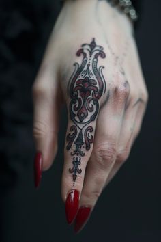 Elaborate black and red tattoo design on the ring finger of a hand with red nails. Sigil Finger Tattoo, Filler Space Tattoo, Gothic Neck Tattoos Women, Cover Up Finger Tattoos, Meaningful Finger Tattoos, Unique Finger Tattoos, Witchy Finger Tattoos, Finger Tattoos Ideas, Finger Tattoos For Women