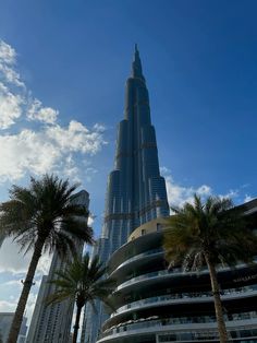 the burj building is surrounded by palm trees