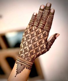 a woman's hand with henna on it