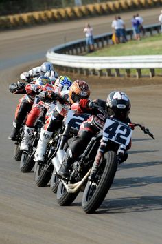 several motorcyclists racing on a race track