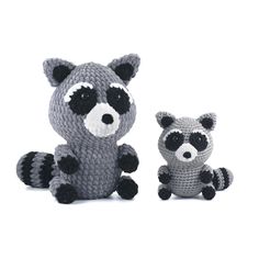 a crocheted raccoon and its baby sitting next to each other