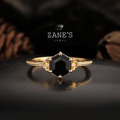 a black diamond ring sitting on top of a table