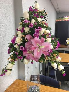 a vase filled with flowers on top of a wooden table