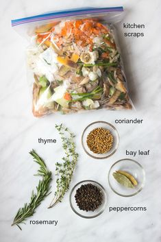 the ingredients to make this salad are laid out on a marble counter top, including carrots, onions, green beans, and seasoning