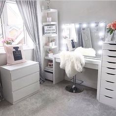 a bedroom with white furniture and lights on the windowsill