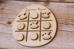 a wooden tic - tacquet game with easter eggs and bunnies on it