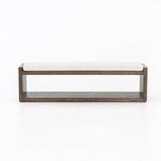 the bench is made from wood and has a white cushion on it's back