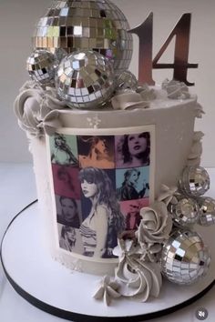 a birthday cake decorated with disco balls and pictures on it's side, including the number four