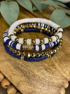 Navy Blue,white, Gold Bracelet Stack - Etsy Cheap Beachy Blue Beaded Bracelets, Navy Blue Bracelets, Cheap Handmade Blue Beaded Bracelets, Navy Clay Bead Bracelet, Dark Bracelet Ideas, Bead Bracelet Ideas Color Combinations, Clay Bead Bracelet Ideas Sports, Blue Stacked Beaded Bracelets, Blue Stacked Bracelets With Round Beads