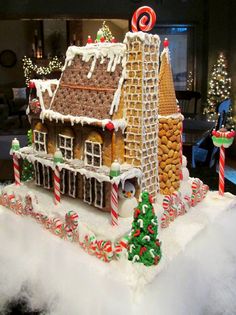 a gingerbread house with candy canes and candies on the roof is decorated for christmas