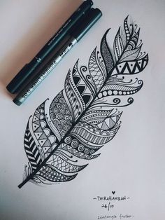 a drawing of a feather with some writing on it and two markers next to it