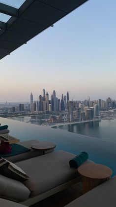 an outdoor lounge area overlooking the water and cityscape in the backgroud