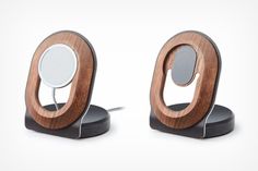 two wooden speakers with metal bases on white background