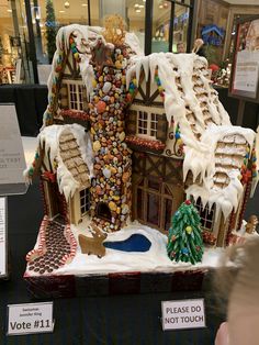 a gingerbread house is on display in a store