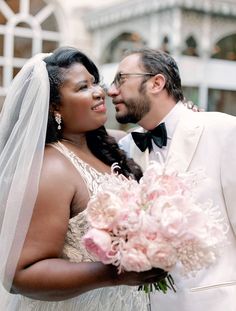 a bride and groom pose for a wedding photo