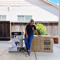 a woman standing next to a cardboard box