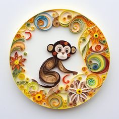 a monkey is sitting in the middle of a circle made out of paper flowers and swirls