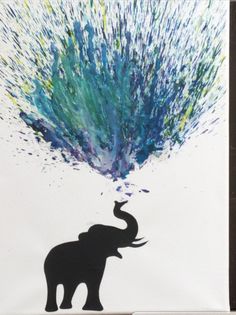 an elephant with its trunk in the air and some paint splatters on it