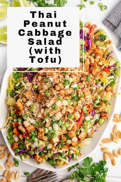 thai peanut cabbage salad with tofu in a white bowl on top of a table