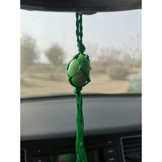 a car dashboard with a green ball hanging from it's side