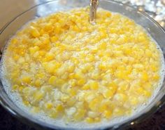 a bowl filled with corn on top of a counter